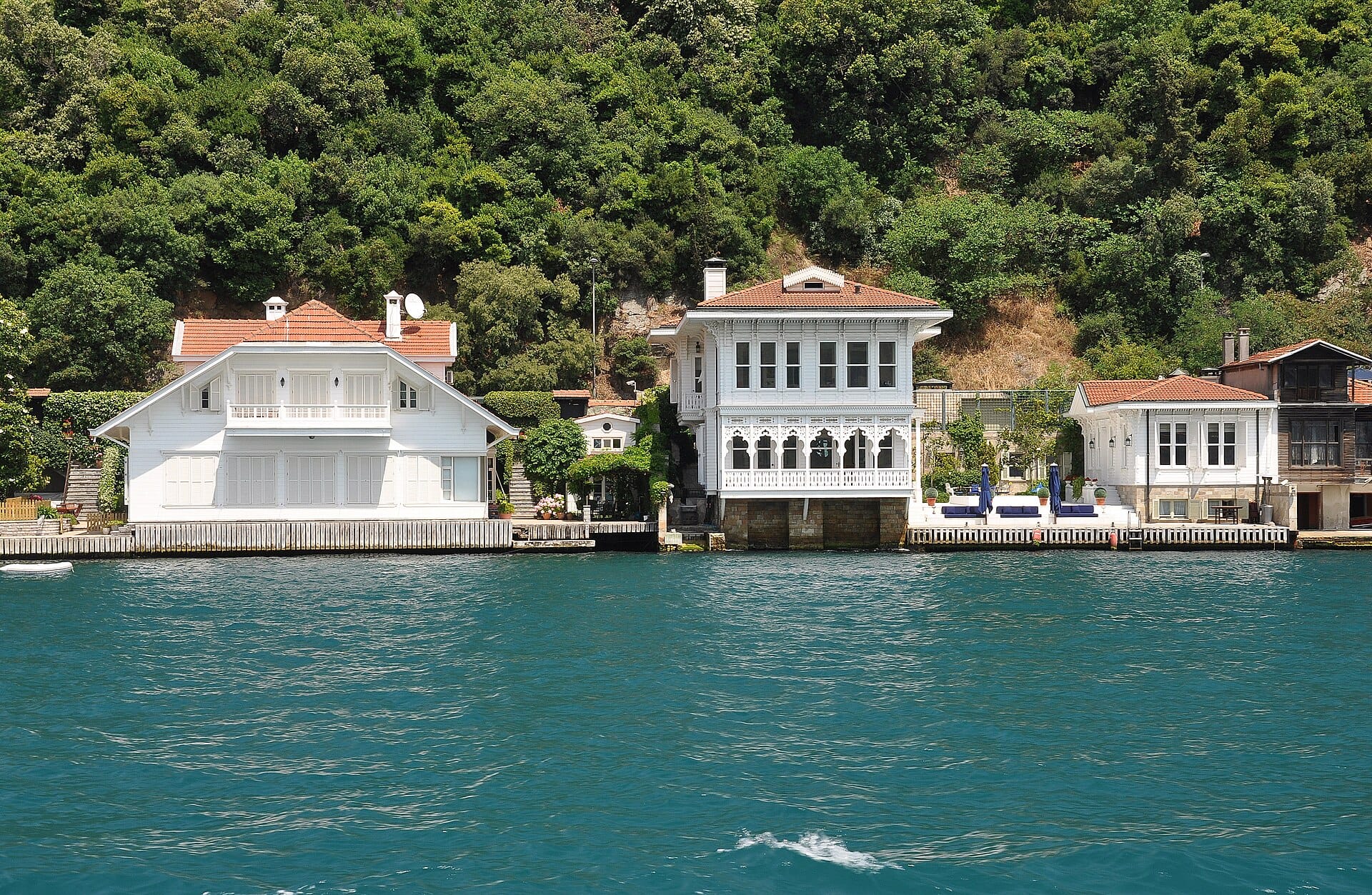 A white wooden waterside mansion, a yalı, on the Bosphorus shore at Kanlıca, backed by green hills