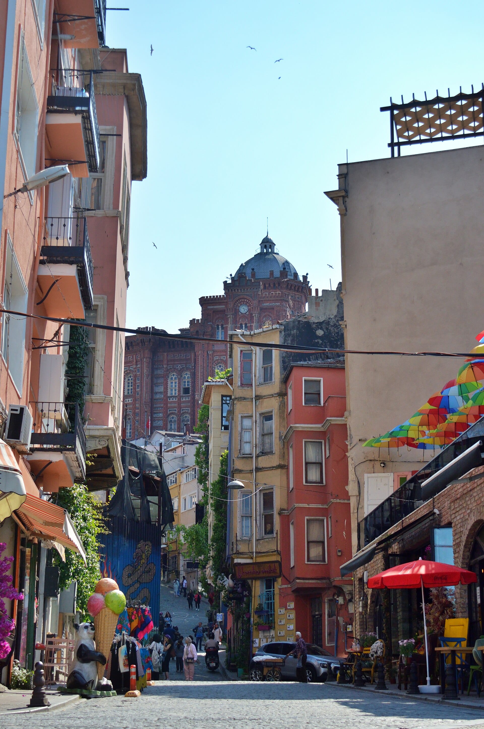 A steep street in Fener lined with painted townhouses and bay windows